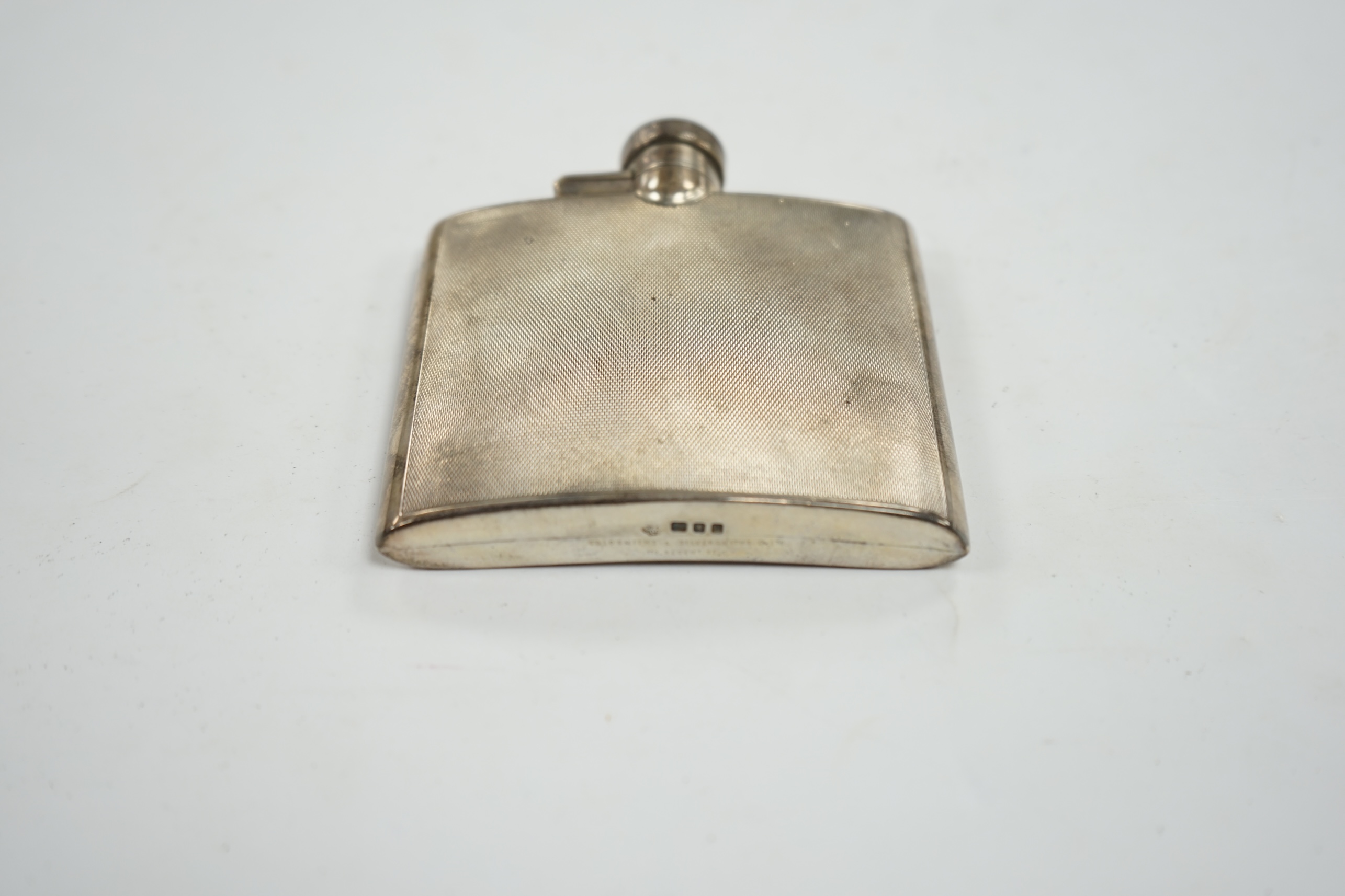 A George VI engine turned silver hip flask, Goldsmiths & Silversmiths Co Ltd, London, 1937, 95mm. Condition - fair